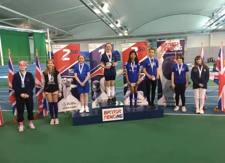 Podium picture of BYC U12 Girls Sabre finalists including silver medalist Orlaith Lindsay Dorward
