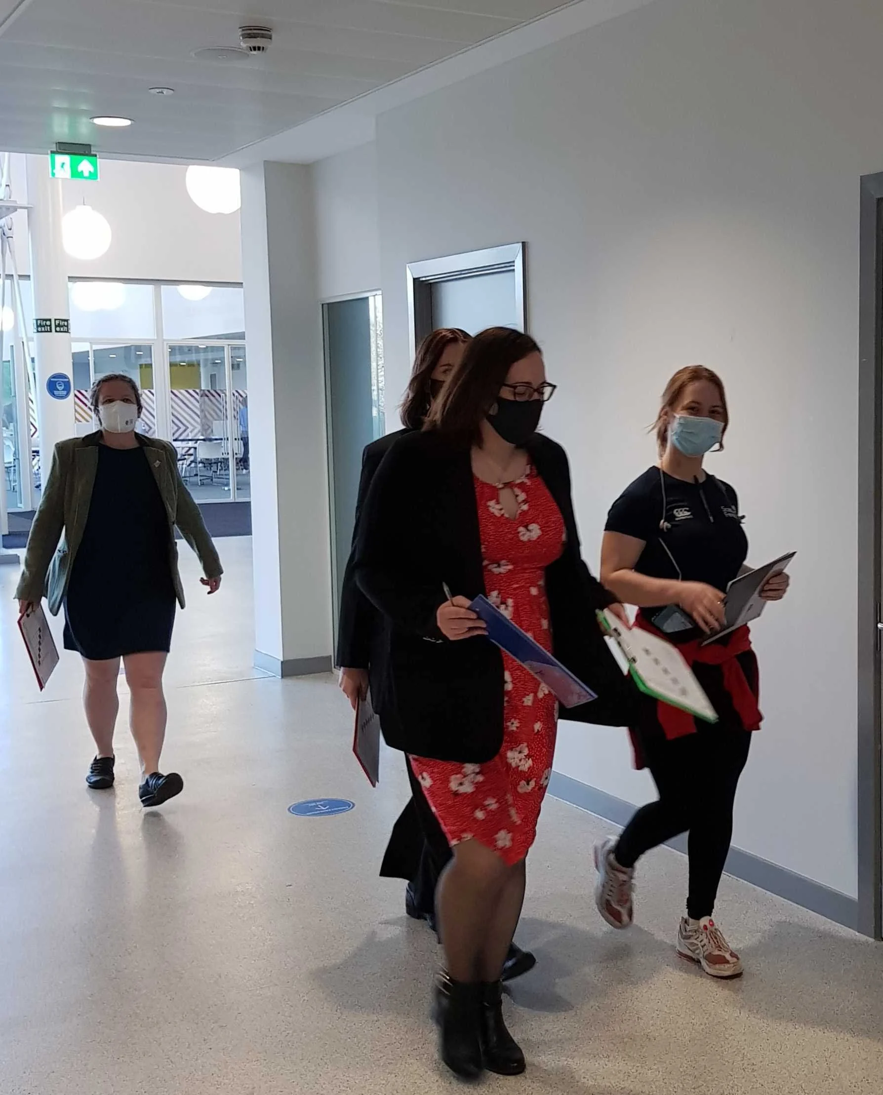 A group of women referees with clipboards making their way to the hall to begin the poule matches