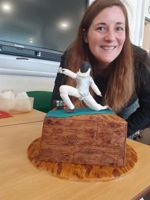 Fleur Club Member at Elgin with a cake topped with a lunging fencer