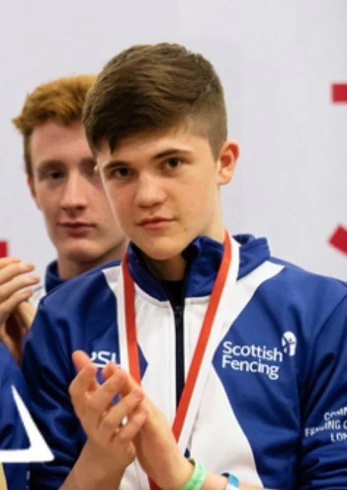 Callum Penman wearing his Scottish Fencing tracksuit top