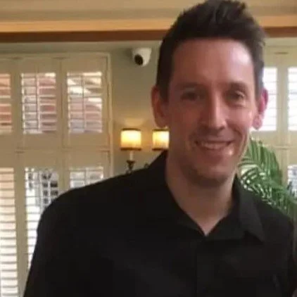 A picture of Alan Martin smartly dressed in a black shirt