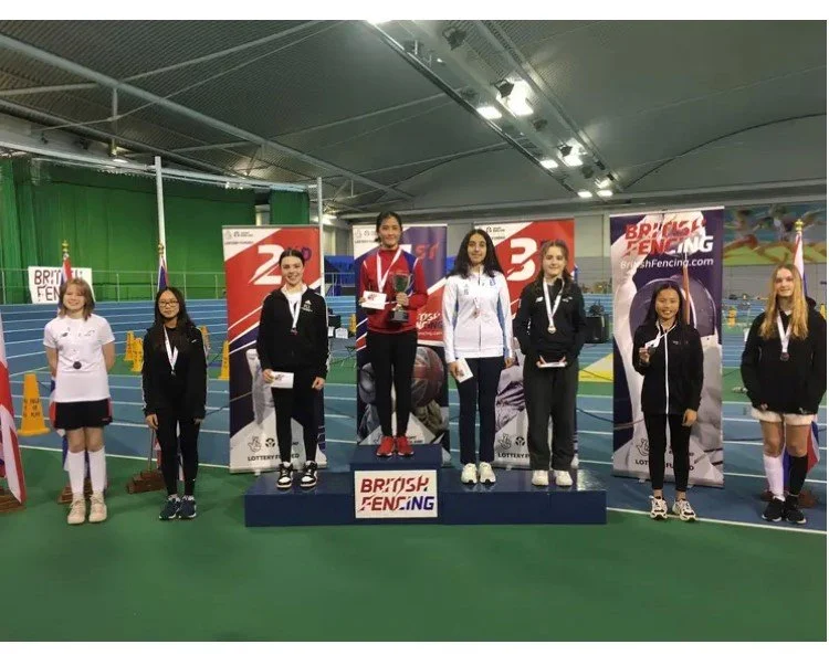 Podium picture of BYC U14 Girls Foilists with Gold medal winner Jac Hu holding her trophy